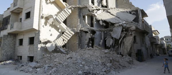 A girl walks near a damaged building in Maarat Al-Nouman, south of Idlib, Syria September 29, 2015. Picture taken September 29, 2015 A girl walks near a damaged building in Maarat Al-Nouman, south of Idlib, Syria September 29, 2015. Picture taken September 29, 2015 - Sputnik International