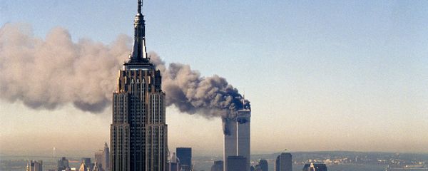 In this Sept. 11, 2001, file photo, the twin towers of the World Trade Center burn behind the Empire State Building in New York. - Sputnik International