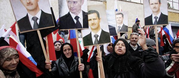 Syrians hold photos of Syrian President Bashar Assad and Russian Prime Minister Vladimir Putin in Damascus, March 4, 2012. Syrians hold photos of Syrian President Bashar Assad and Russian Prime Minister Vladimir Putin in Damascus, March 4, 2012. - Sputnik International
