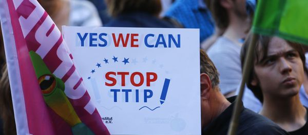 Demonstrators hold a sign against the TTIP contract during a protest. Demonstrators hold a sign against the TTIP contract during a protest. - Sputnik International