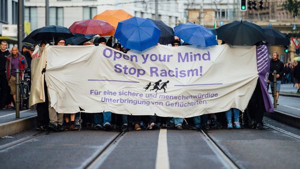 In this Monday July 27, 2015 picture demonstrators march through the city of Dresden, eastern Germany. They carried a banner reading: Open Your Mind - Stop Racism. In this Monday July 27, 2015 picture demonstrators march through the city of Dresden, eastern Germany. They carried a banner reading: Open Your Mind - Stop Racism. - Sputnik International