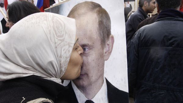 Syrian woman kisses a poster of Russian President Vladimir Putin during a pro-Syrian government protest in front of the Russian Embassy in Damascus, Syria Syrian woman kisses a poster of Russian President Vladimir Putin during a pro-Syrian government protest in front of the Russian Embassy in Damascus, Syria - Sputnik International