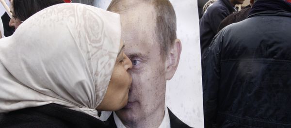 Syrian woman kisses a poster of Russian President Vladimir Putin during a pro-Syrian government protest in front of the Russian Embassy in Damascus, Syria Syrian woman kisses a poster of Russian President Vladimir Putin during a pro-Syrian government protest in front of the Russian Embassy in Damascus, Syria - Sputnik International