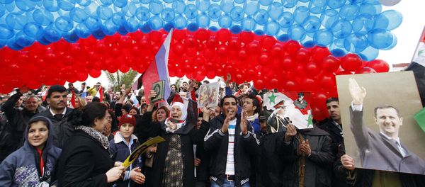 Pro-Syrian government protesters gather under a large Russian flag made with balloons in Damascus, Syria Pro-Syrian government protesters gather under a large Russian flag made with balloons in Damascus, Syria - Sputnik International