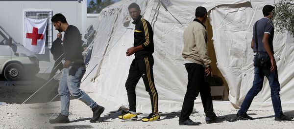 Migrants walk by the tents at a reception camp at Kokkinotrimithia village outside Cyprus' capital Nicosia Migrants walk by the tents at a reception camp at Kokkinotrimithia village outside Cyprus' capital Nicosia - Sputnik International