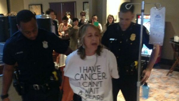 Atlanta police arrest health advocate and cancer survivor Zahara Heckscher outside of negotiations for the Trans-Pacific Partnership. Atlanta police arrest health advocate and cancer survivor Zahara Heckscher outside of negotiations for the Trans-Pacific Partnership. - Sputnik International