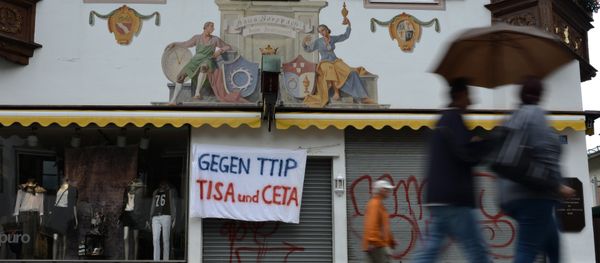 A banner reading 'Against TTIP, TiSA and CETA' hangs over the entrance of a shop in Garmisch-Partenkirchen, southern Germany A banner reading 'Against TTIP, TiSA and CETA' hangs over the entrance of a shop in Garmisch-Partenkirchen, southern Germany - Sputnik International