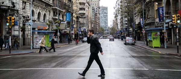 A man crosses the capital's main avenue, during a full-day general strike in Montevideo, Uruguay. A man crosses the capital's main avenue, during a full-day general strike in Montevideo, Uruguay. - Sputnik International