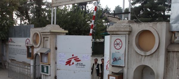 Afghan guards stand at the gate of Medecins Sans Frontieres (MSF) hospital after an air strike in the city of Kunduz, Afghanistan - Sputnik International