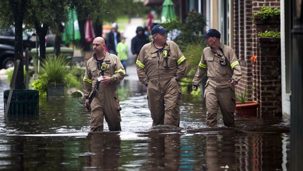 (L-R) Norman Beauregard, Kevin Attender and Chris Rogers of the Georgetown Fire Department, wade through flooded Front Street in Georgetown, South Carolina October 4, 2015. (L-R) Norman Beauregard, Kevin Attender and Chris Rogers of the Georgetown Fire Department, wade through flooded Front Street in Georgetown, South Carolina October 4, 2015. - Sputnik International