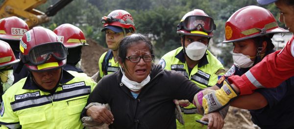Rescue workers help a woman after she identified two family members as their bodies are retrieved from the site of a mudslide in Cambray, a neighborhood in the suburb of Santa Catarina Pinula, on the outskirts of Guatemala City, Saturday, Oct. 3, 2015. Rescue workers help a woman after she identified two family members as their bodies are retrieved from the site of a mudslide in Cambray, a neighborhood in the suburb of Santa Catarina Pinula, on the outskirts of Guatemala City, Saturday, Oct. 3, 2015. - Sputnik International