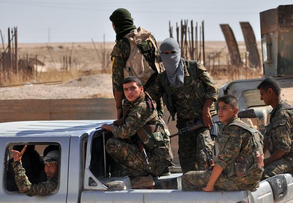 Fighters from the Kurdish People's Protection Units (YPG) sit in the back of a vehicle in the al-Zohour neighbourhood of northeastern Syrian city of Hasakeh on August 2, 2015, a week after Syrian troops and Kurdish fighters ousted the Islamic State group from Hasakeh - Sputnik International