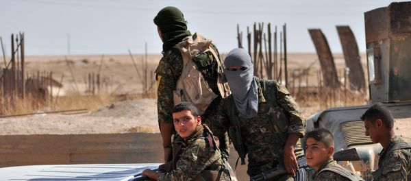 Fighters from the Kurdish People's Protection Units (YPG) sit in the back of a vehicle Fighters from the Kurdish People's Protection Units (YPG) sit in the back of a vehicle - Sputnik International