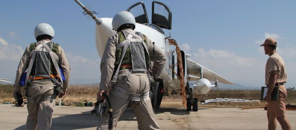 Russian pilots near a Su-24 aircraft before a mission, at the Khmeimim airbase in Syria Russian pilots near a Su-24 aircraft before a mission, at the Khmeimim airbase in Syria - Sputnik International