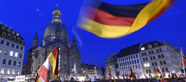 Protestors wave a German flag in front of the Church of Our Lady during a demonstration of PEGIDA (Patriotic Europeans against the Islamization of the West) in Dresden, eastern Germany, Monday, Oct. 5, 2015. Protestors wave a German flag in front of the Church of Our Lady during a demonstration of PEGIDA (Patriotic Europeans against the Islamization of the West) in Dresden, eastern Germany, Monday, Oct. 5, 2015. - Sputnik International