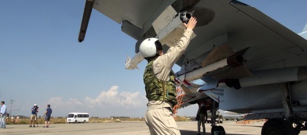 In this photo taken on Monday, Oct. 5, 2015, a Russian pilot fixes an air-to-air missile at his Su-30 jet fighter before a take off at Hmeimim airbase in Syria In this photo taken on Monday, Oct. 5, 2015, a Russian pilot fixes an air-to-air missile at his Su-30 jet fighter before a take off at Hmeimim airbase in Syria - Sputnik International
