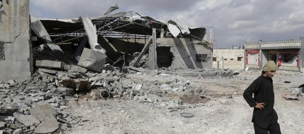 A man inspects a site hit by what activists said were airstrikes carried out by the Russian air force in the town of Babila, in the southern countryside of Idlib, Syria, October 7, 2015 - Sputnik International