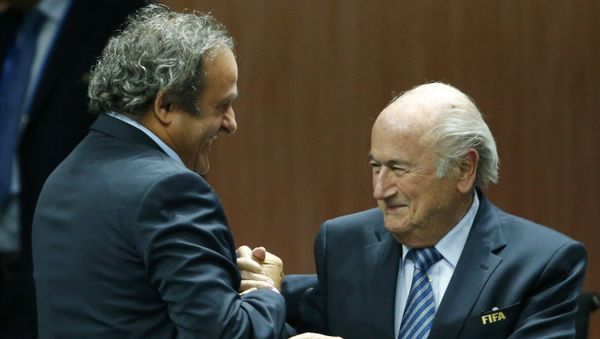 UEFA President Michel Platini (L) congratulates FIFA President Sepp Blatter after he was re-elected at the 65th FIFA Congress in Zurich, Switzerland, in this May 29, 2015 file photo - Sputnik International