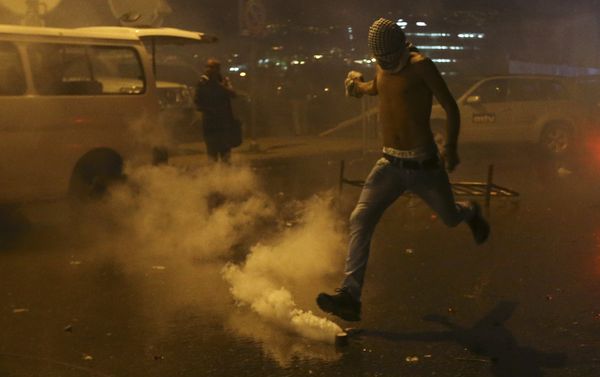 A Lebanese anti-government protester kicks back a tear gas canister shot by security forces during a protest against the ongoing trash crisis and government corruption, in downtown Beirut, Lebanon, Thursday, Oct. 8, 2015. Lebanese security forces used water cannons and eventually fired tear gas canisters to disperse dozens of anti-government protesters who tried to get past security barricades and reach parliament. A Lebanese anti-government protester kicks back a tear gas canister shot by security forces during a protest against the ongoing trash crisis and government corruption, in downtown Beirut, Lebanon, Thursday, Oct. 8, 2015. Lebanese security forces used water cannons and eventually fired tear gas canisters to disperse dozens of anti-government protesters who tried to get past security barricades and reach parliament. - Sputnik International