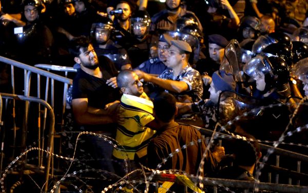 Lebanese protesters clash with riot police during a protest in Martyr square, Downtown Beirut, Lebanon October 8, 2015. Lebanese security forces fired a water cannon at scores of anti-government protesters on Thursday, Reuters witnesses said. The crowd chanted the people want the fall of the regime as riot police surrounded them in downtown Beirut. Lebanon has been hit by weeks of protests by people angry about political paralysis, corruption and poor infrastructure in the country. Lebanese protesters clash with riot police during a protest in Martyr square, Downtown Beirut, Lebanon October 8, 2015. Lebanese security forces fired a water cannon at scores of anti-government protesters on Thursday, Reuters witnesses said. The crowd chanted the people want the fall of the regime as riot police surrounded them in downtown Beirut. Lebanon has been hit by weeks of protests by people angry about political paralysis, corruption and poor infrastructure in the country. - Sputnik International