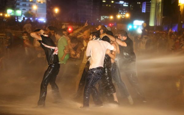 Protesters hold on to each other as they are sprayed with water from police water cannons in Martyr square, downtown Beirut, Lebanon October 8, 2015. Lebanese security forces fired tear gas and water cannons to break up an anti-government protest in Beirut on Thursday, and the country's fractious leaders postponed talks aimed at resolving a political crisis that is feeding public discontent. Protesters hold on to each other as they are sprayed with water from police water cannons in Martyr square, downtown Beirut, Lebanon October 8, 2015. Lebanese security forces fired tear gas and water cannons to break up an anti-government protest in Beirut on Thursday, and the country's fractious leaders postponed talks aimed at resolving a political crisis that is feeding public discontent. - Sputnik International