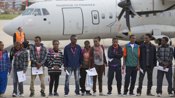 Eritrean refugee pose for a group photo in front of an Italian Financial police aircraft which will take them to Sweden, at Rome's Ciampino airport, Friday, Oct. 9, 2015. Eritrean refugee pose for a group photo in front of an Italian Financial police aircraft which will take them to Sweden, at Rome's Ciampino airport, Friday, Oct. 9, 2015. - Sputnik International