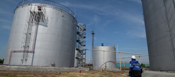 An employee of Gazprom-Neft's Novosibirsk petroleum base near fuel storage tanks An employee of Gazprom-Neft's Novosibirsk petroleum base near fuel storage tanks - Sputnik International