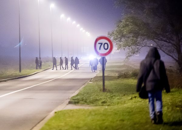 Migrants walk on a road towards the Eurotunnel site in Coquelles, northern France, on October 3, 2015.  - Sputnik International