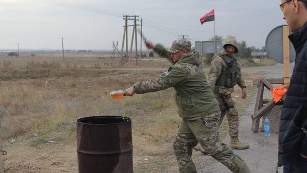 Right Sector activist smashes a bottle of expensive alcohol over a barrel. - Sputnik International