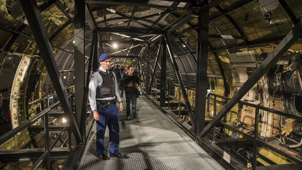 A military policeman stands guard in the reconstructed MH17 airplane after the presentation of the final report into the crash of July 2014 of Malaysia Airlines flight MH17 over Ukraine, in Gilze Rijen, the Netherlands, October 13, 2015 - Sputnik International