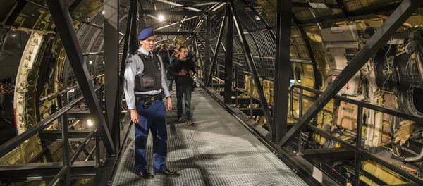 A military policeman stands guard in the reconstructed MH17 airplane after the presentation of the final report into the crash of July 2014 of Malaysia Airlines flight MH17 over Ukraine, in Gilze Rijen, the Netherlands, October 13, 2015 - Sputnik International