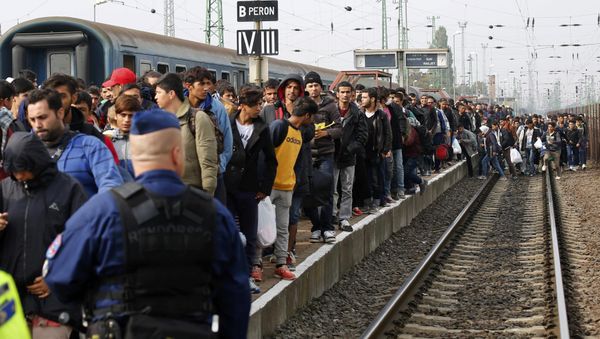 A Hungarian police officer watches as migrants arrive at the train station in Hegyeshalom, Hungary. File photo A Hungarian police officer watches as migrants arrive at the train station in Hegyeshalom, Hungary. File photo - Sputnik International