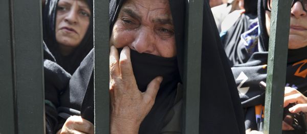 An Iranian mourner weeps during a funeral ceremony, attended by thousands of mourners in Tehran, Iran, for some of the pilgrims who were killed in a stampede during the hajj pilgrimage in Saudi Arabia in September 2015. An Iranian mourner weeps during a funeral ceremony, attended by thousands of mourners in Tehran, Iran, for some of the pilgrims who were killed in a stampede during the hajj pilgrimage in Saudi Arabia in September 2015. - Sputnik International