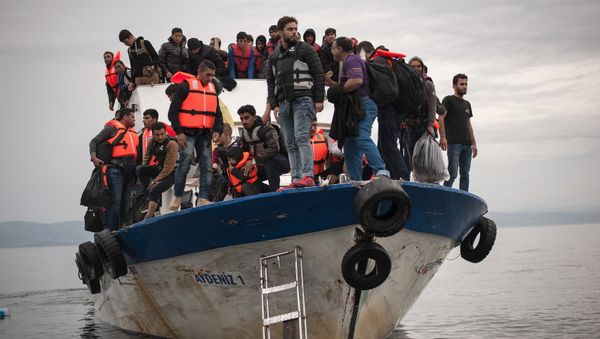 Migrants and refugees are seen aboard a Turkish fishing boat as they arrive on the Greek island of Lesbos after crossing a part of the Aegean Sea from the Turkish coast to Lesbos October 11, 2015 Migrants and refugees are seen aboard a Turkish fishing boat as they arrive on the Greek island of Lesbos after crossing a part of the Aegean Sea from the Turkish coast to Lesbos October 11, 2015 - Sputnik International