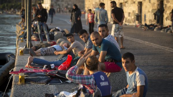 Migrants rest on an embankment of the port while waiting to be registered at the southeastern island of Kos, Greece, Wednesday, Aug. 19, 2015 Migrants rest on an embankment of the port while waiting to be registered at the southeastern island of Kos, Greece, Wednesday, Aug. 19, 2015 - Sputnik International