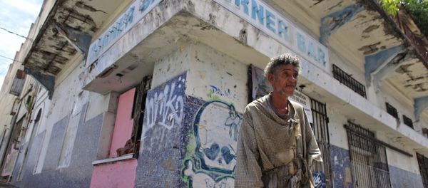 In this Aug. 2, 2015, file photo, a homeless man stands in front of a closed down business in Puerta de Tierra in the outskirts of Old San Juan, Puerto Rico In this Aug. 2, 2015, file photo, a homeless man stands in front of a closed down business in Puerta de Tierra in the outskirts of Old San Juan, Puerto Rico - Sputnik International