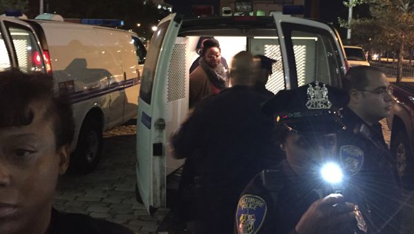 Protesters are placed into a van by police early Thursday, Oct. 15, 2015, in Baltimore Protesters are placed into a van by police early Thursday, Oct. 15, 2015, in Baltimore - Sputnik International