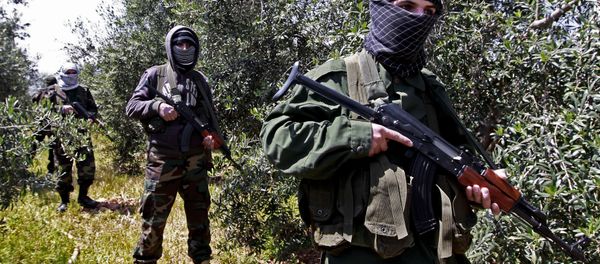 In this Friday, April 12, 2013 photo, members of the Lebanese pro-Syrian Popular Committees stand guard at the Lebanon-Syria border, near the northeastern Lebanese town of al-Qasr, Lebanon. Masked men in camouflage toting Kalashnikov rifles fan out through a dusty olive orchard. In this Friday, April 12, 2013 photo, members of the Lebanese pro-Syrian Popular Committees stand guard at the Lebanon-Syria border, near the northeastern Lebanese town of al-Qasr, Lebanon. Masked men in camouflage toting Kalashnikov rifles fan out through a dusty olive orchard. - Sputnik International