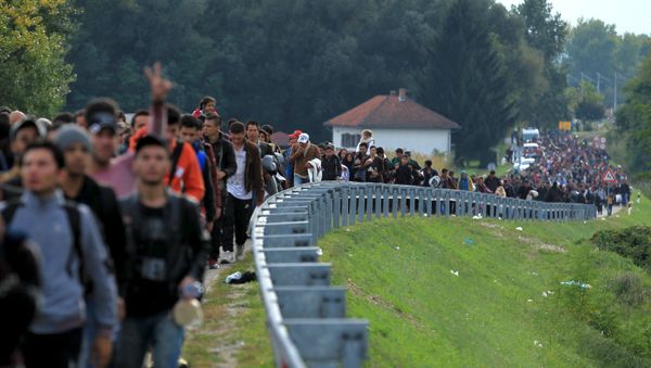 Migrants walk towards the Hungarian border after arriving at the train station in Botovo, Croatia October 6, 2015 - Sputnik International