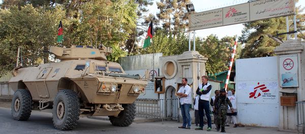 Christopher Stokes, second left, the general director of Doctors Without Borders and his colleague stand as an Afghan National Army vehicle guards at the gate of its hospital after U.S. troops left the area in Kunduz, Afghanistan, Thursday, Oct. 15, 2015. Christopher Stokes, second left, the general director of Doctors Without Borders and his colleague stand as an Afghan National Army vehicle guards at the gate of its hospital after U.S. troops left the area in Kunduz, Afghanistan, Thursday, Oct. 15, 2015. - Sputnik International
