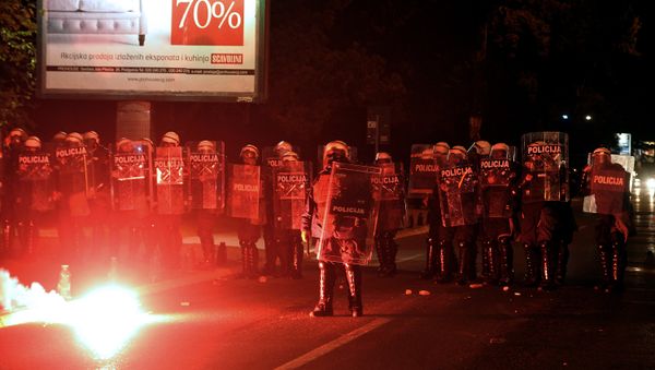Demonstrators throwing torches at Montenegrin police officers during anti-government protest in Podgorica, Montenegro, Sunday, Oct. 18, 2015. - Sputnik International