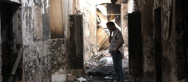 In this Friday, Oct. 16, 2015 photo, an employee of Doctors Without Borders walks inside the charred remains of their hospital after it was hit by a U.S. airstrike in Kunduz, Afghanistan. In this Friday, Oct. 16, 2015 photo, an employee of Doctors Without Borders walks inside the charred remains of their hospital after it was hit by a U.S. airstrike in Kunduz, Afghanistan. - Sputnik International