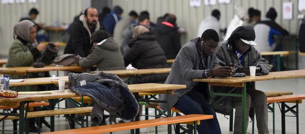 File Photo: Migrants use their cell phones in a canteen in a refugee camp in Celle, Lower-Saxony, Germany October 15, 2015. - Sputnik International