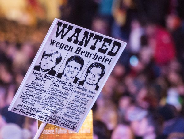 Protestors hold a banner with manipulated images of German Chancellor Angela Merkel, German Economy Minister Sigmar Gabriel and German President Joachim Gauck, from left to right, during a demonstration of the PEGIDA (Patriotic Europeans against the Islamization of the West), marking the first anniversary of the anti-Islam group in Dresden, eastern Germany, Monday, Oct. 19, 2015. Protestors hold a banner with manipulated images of German Chancellor Angela Merkel, German Economy Minister Sigmar Gabriel and German President Joachim Gauck, from left to right, during a demonstration of the PEGIDA (Patriotic Europeans against the Islamization of the West), marking the first anniversary of the anti-Islam group in Dresden, eastern Germany, Monday, Oct. 19, 2015. - Sputnik International