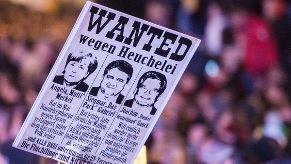 Protestors hold a banner with manipulated images of German Chancellor Angela Merkel, German Economy Minister Sigmar Gabriel and German President Joachim Gauck, from left to right, during a demonstration of the PEGIDA (Patriotic Europeans against the Islamization of the West), marking the first anniversary of the anti-Islam group in Dresden, eastern Germany, Monday, Oct. 19, 2015. Protestors hold a banner with manipulated images of German Chancellor Angela Merkel, German Economy Minister Sigmar Gabriel and German President Joachim Gauck, from left to right, during a demonstration of the PEGIDA (Patriotic Europeans against the Islamization of the West), marking the first anniversary of the anti-Islam group in Dresden, eastern Germany, Monday, Oct. 19, 2015. - Sputnik International