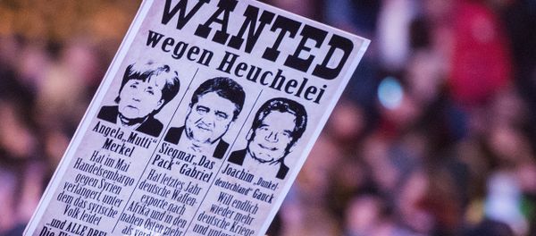 Protestors hold a banner with manipulated images of German Chancellor Angela Merkel, German Economy Minister Sigmar Gabriel and German President Joachim Gauck, from left to right, during a demonstration of the PEGIDA (Patriotic Europeans against the Islamization of the West), marking the first anniversary of the anti-Islam group in Dresden, eastern Germany, Monday, Oct. 19, 2015. Protestors hold a banner with manipulated images of German Chancellor Angela Merkel, German Economy Minister Sigmar Gabriel and German President Joachim Gauck, from left to right, during a demonstration of the PEGIDA (Patriotic Europeans against the Islamization of the West), marking the first anniversary of the anti-Islam group in Dresden, eastern Germany, Monday, Oct. 19, 2015. - Sputnik International