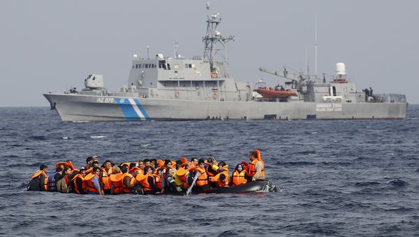 Syrian refugees call for help and empty water from their flooding raft as they approach the Greek island of Lesbos past a Greek coast guard vessel October 20, 2015 Syrian refugees call for help and empty water from their flooding raft as they approach the Greek island of Lesbos past a Greek coast guard vessel October 20, 2015 - Sputnik International