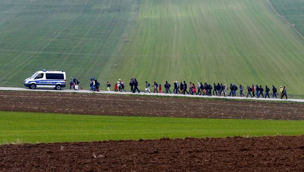 Migrants are escorted by German police to a registration centre, after crossing the Austrian-German border in Wegscheid near Passau, Germany, October 20, 2015 - Sputnik International