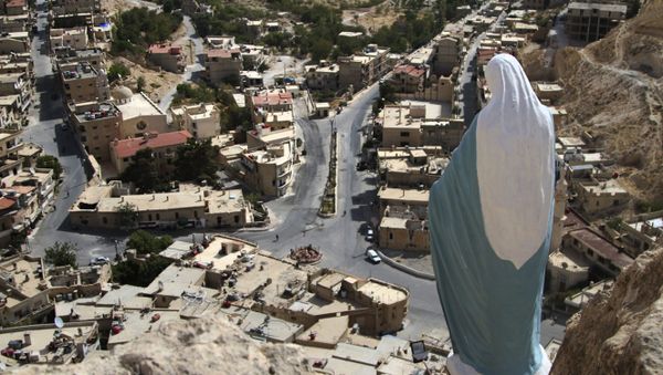 In this photo taken on Sunday, Oct. 18, 2015, a statue of the Virgin Mary overlooks the village of Maaloula, north of Damascus, Syria - Sputnik International