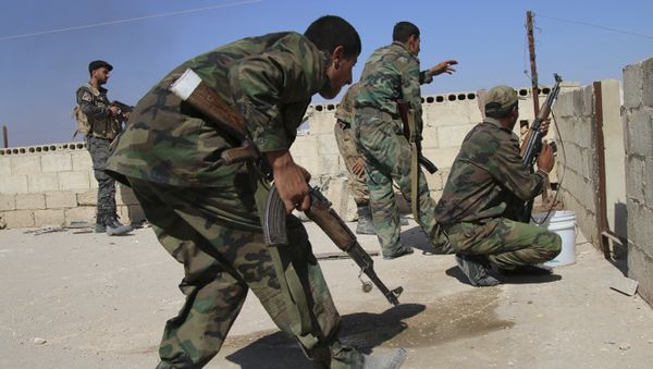 In this photo taken on Sunday, Oct. 11, 2015, Syrian soldiers fire repelling an attack in Achan, Hama province, Syria - Sputnik International